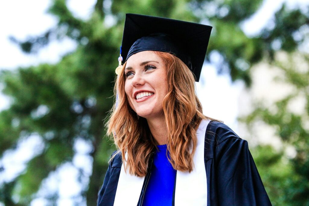 Graduate holding a degree certificate after studying in the UK
