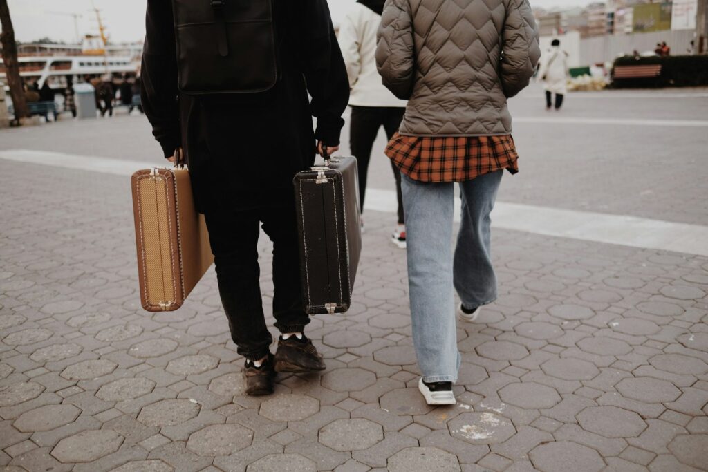 Couple travelling with luggage to join each other in the UK