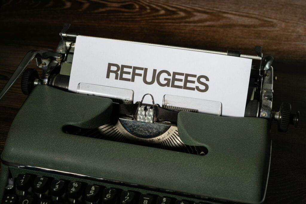 Typewriter with a sheet reading Refugees