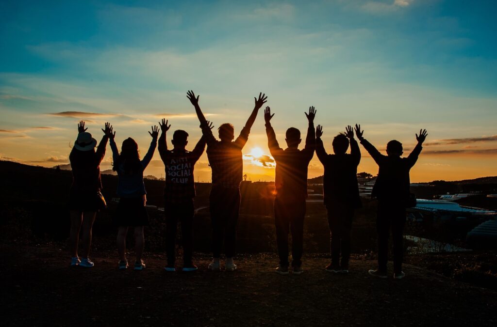 People celebrating together at sunset